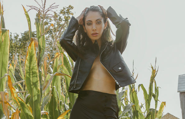 Woman in leather jacket in a corn field