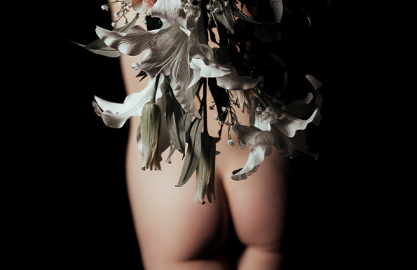 A woman's bare bottom with flowers in front